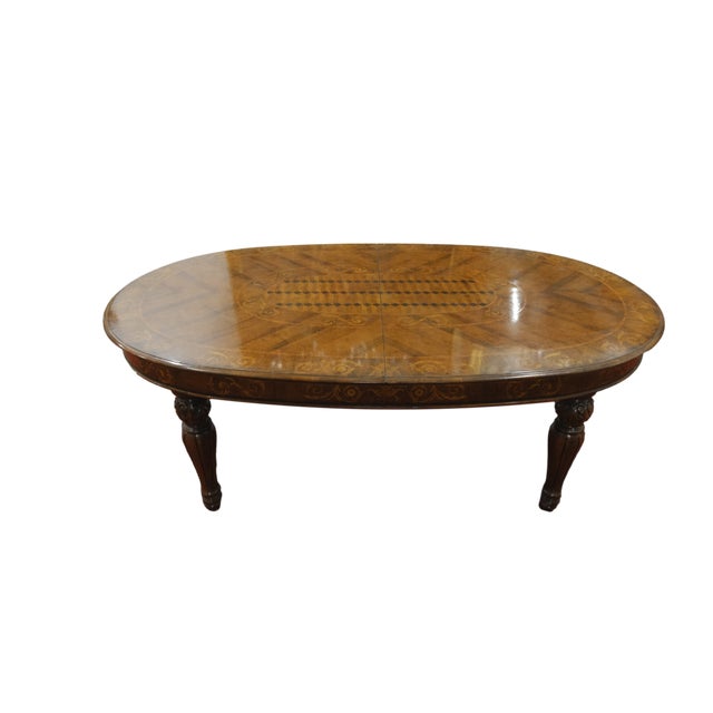 An imposing Victorian-style table, dating back to the 1900s, made of Italian walnut, adorned with a multitude of precious...