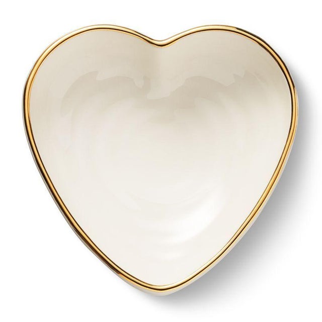 This ribbed ceramic dish is crafted in the shape of a heart with an artisanal ribbed texture and is enhanced with gold...