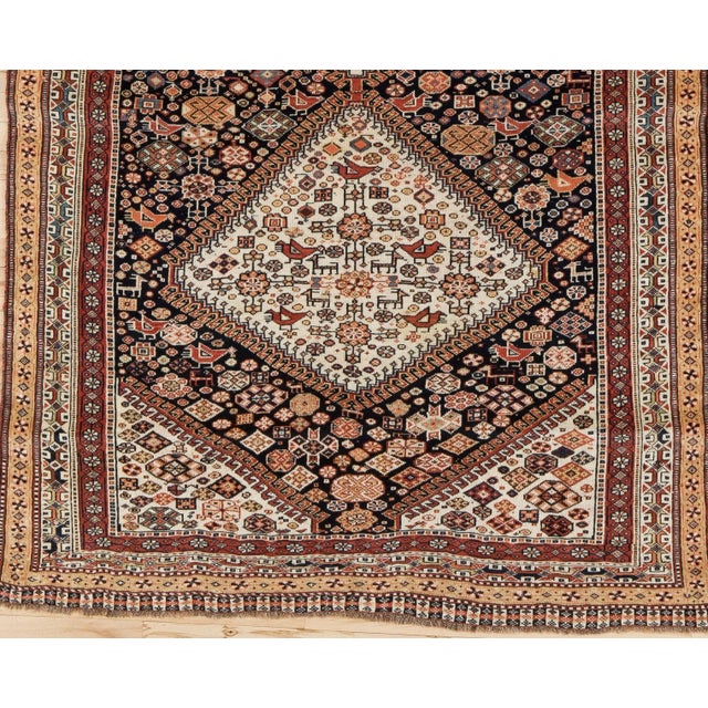 This classic all wool SW Persian nomadic scatter shows a navy field closely scattered with...
