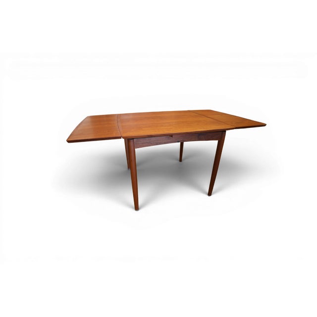 A very unusual and neat Danish teak dining table designed by Poul Hundevad for Hundevad & Co, Denmark. The table is square...