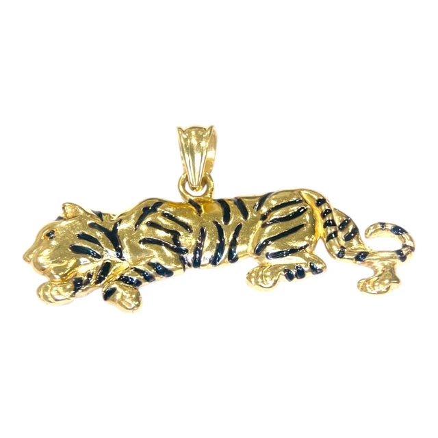 Vintage tiger pendant crafted in 14k yellow gold with enamel detailing. The design features a prowling tiger with...