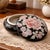 Vintage ceramic ginger jar or trinket box features a striking black glaze base adorned with a hand-painted floral motif....