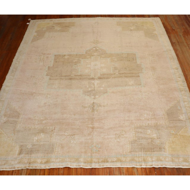 A large room-size mid 20th century Turkish rug in predominantly in Pink Measures: 10'5'' x 12'3".
