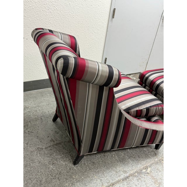 Design Plus Gallery presents Set of Rolled Arm Wing Chair + Ottoman from Baker Furniture. The set has a satin upholstery...