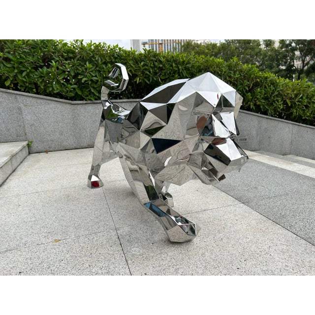 ✦ Handcrafted in stainless steel — a 41"x13"h.27" (cm.104x33x69) geometric lion sculpture with a mirror-polished finish....
