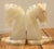 Hand-carved white and beige onyx marble bookends fashioned into a pair of horse heads. These stylized horse heads are...