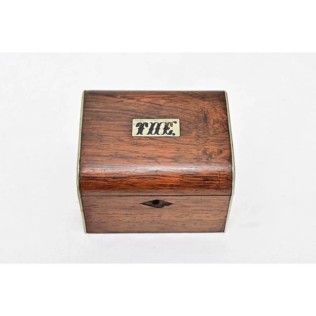 An English oak snuff box from the early 1900’s. An inset silver plate is monogrammed “T H E”. The top opens on brass...
