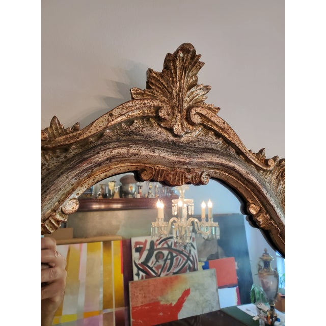 An original period Italian carved wood Hollywood Regency glamour mirror. Having rich silver and gold leaf applications...