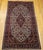 "An early 20th century hand-knotted Persian Kashan rug, distinguished by its rare and coveted ivory field color and...