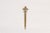 A vintage brass letter opener with a cast fleur-de-lys handle and tapered blade. The brass has a warm aged patina with...