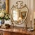 Antique late 19th-century French-style Rococo Revival fireplace screen featuring a shaped beveled mirror within an ornate...