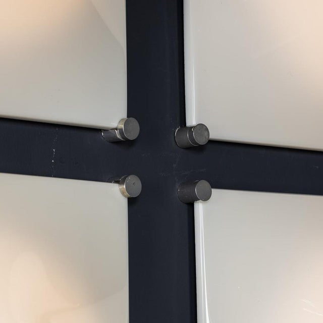 Vintage 20th Century set of six iGuzzini Dada wall lights, crafted from white acrylic glass with metal frames. These...