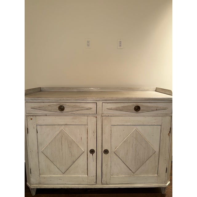 Gustavian painted sideboard with gallery top, canted front, fluting top drawers, lower paneled drawers, applied reeded...