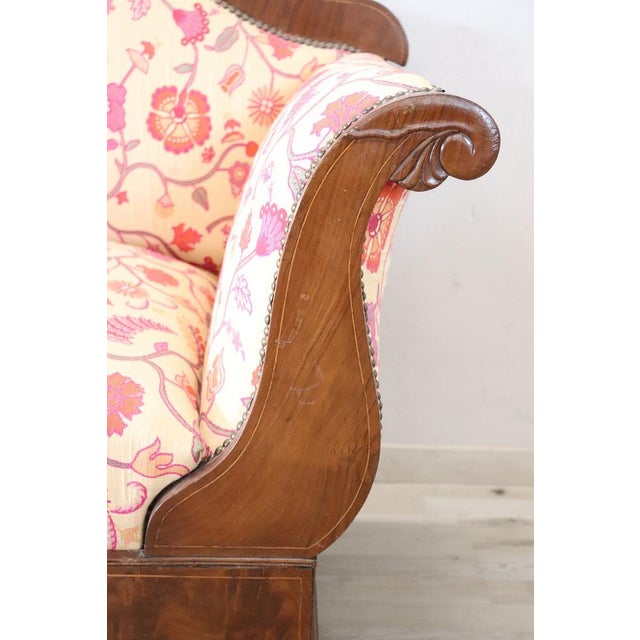 We offer this antique Italian sofa dating back to the first half of the 19th century. The sofa features a solid walnut...
