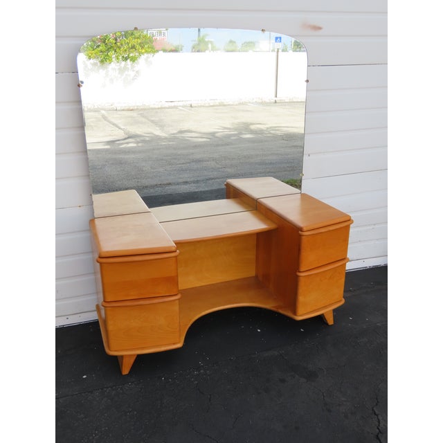 This beautiful Set of Vanity Table and Stool was made by Heywood Wakefield, and it is stamped. It showcases the timeless...