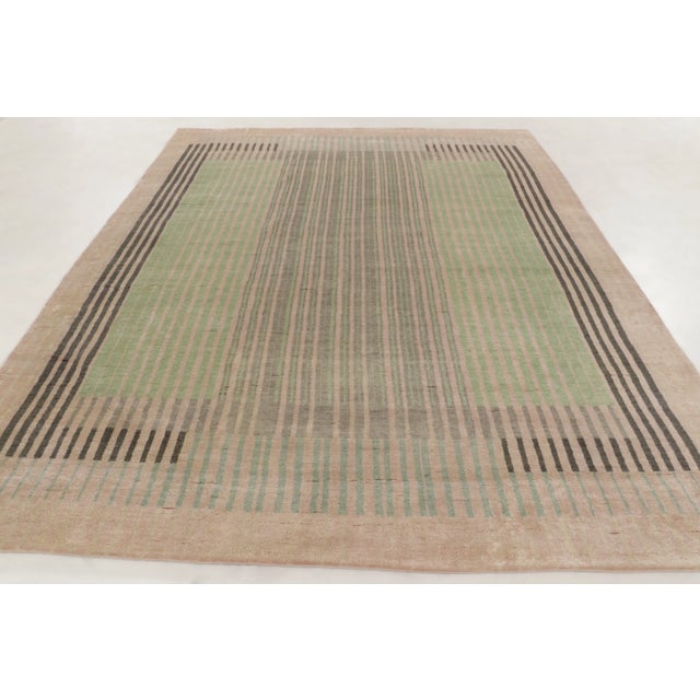 This contemporary 9x12 Art Deco rug, hand-knotted in wool, explores geometric form through fine linear striping and a bold...