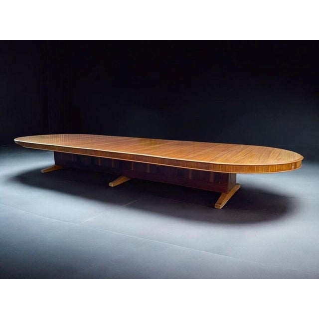 Monumentally large meeting or conference table, 1960s, mahogany veneered beech or softwood construction on skid-like feet...