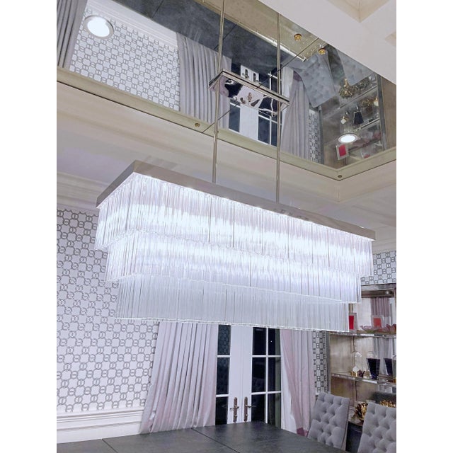 This is a custom made chandelier by LMD Custom Lighting. Nickel polished finish and costume made glass tubes with the...