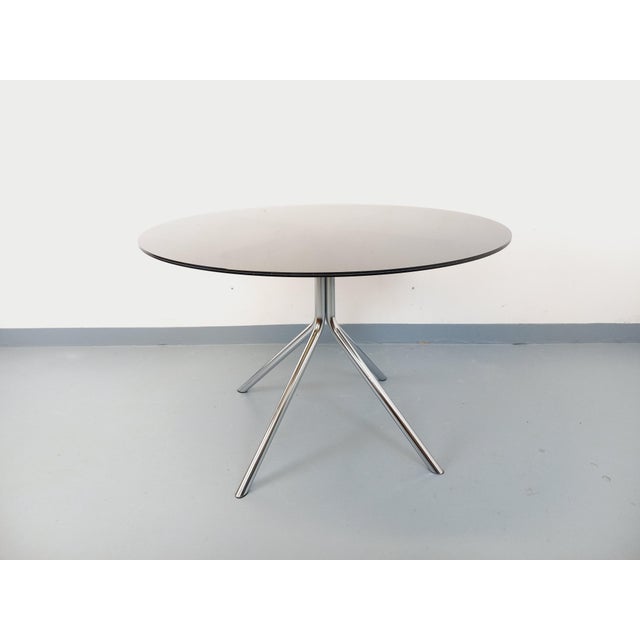 Vintage 1970s round dining table, Space Age style, round acrylic glass top with a smoked glass-like finish and a black...
