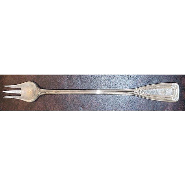 Elegant solid sterling silver St Dunstan olive fork by Tiffany, find condition and a nice feel in the hand. A nice 'M'...