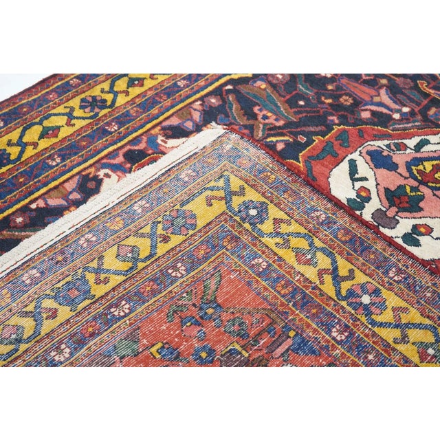 The particularly bold ecru medallion features four internal palmettes and four pointed finials. The red ground is centred...