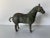 A striking vintage bronze sculpture of a horse rendered in a timeless, stylized form. This bronze figure features a...