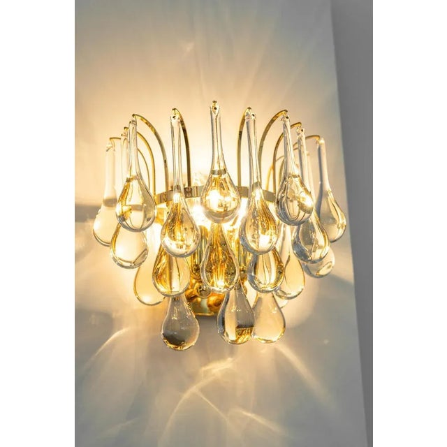 A stunning pair of golden sconces, made by christoph palme, germany, circa 1970-1979. It’s composed of murano teardrop...