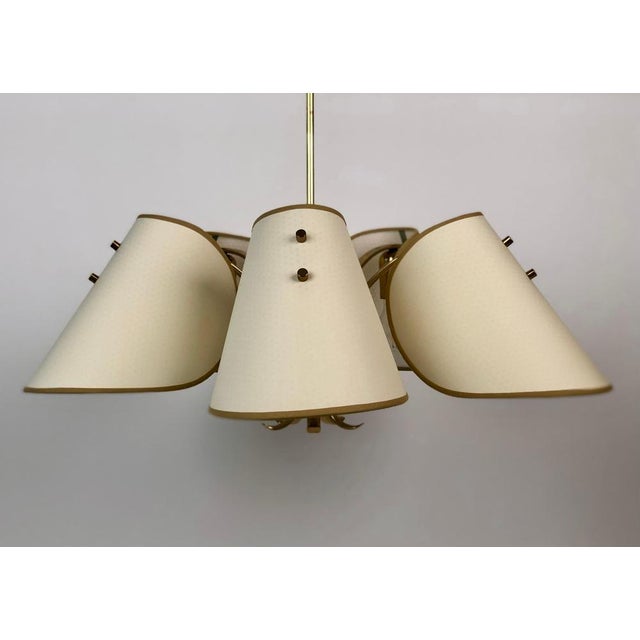 Brass chandelier with five shades produced from the Austrian company Rupert Nikoll about 1960. The corpus is made in a...