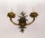 An antique, solid brass organic-shaped sconce with a rich, dark patina. The cast wall mount sprouts acanthus leaves with...