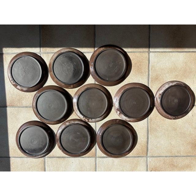 These handcrafted plates, attributed to the Serocka pottery workshop, showcase the characteristic combination of warm,...