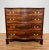 A fine antique George III serpentine chest, ca. 1790, with flamed mahogany drawers over bracket feet. Original brasses...