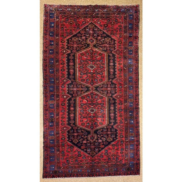 Antique hand-knotted rug from the Zanjan region of northwest Iran, featuring a bold geometric composition with a series of...