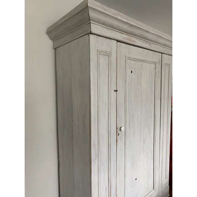 Stunning whitewashed solid pine armoire with white porcelain knob. Featuring simple lines and understated elegance, this...