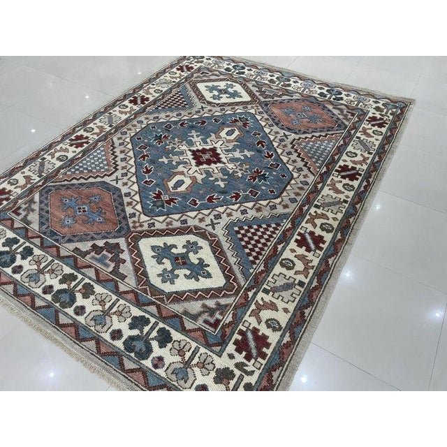 This gray wool rug features a hand knotted pile construction and measures 8 x 10 feet. Crafted in India, this floor...