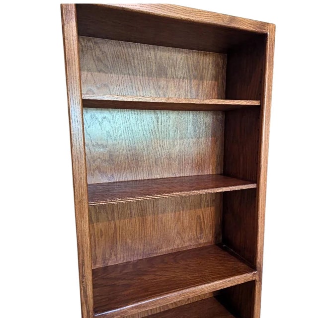 Classic vintage solid wood bookcase featuring a warm oak finish and beautiful natural wood grain throughout. The tall,...