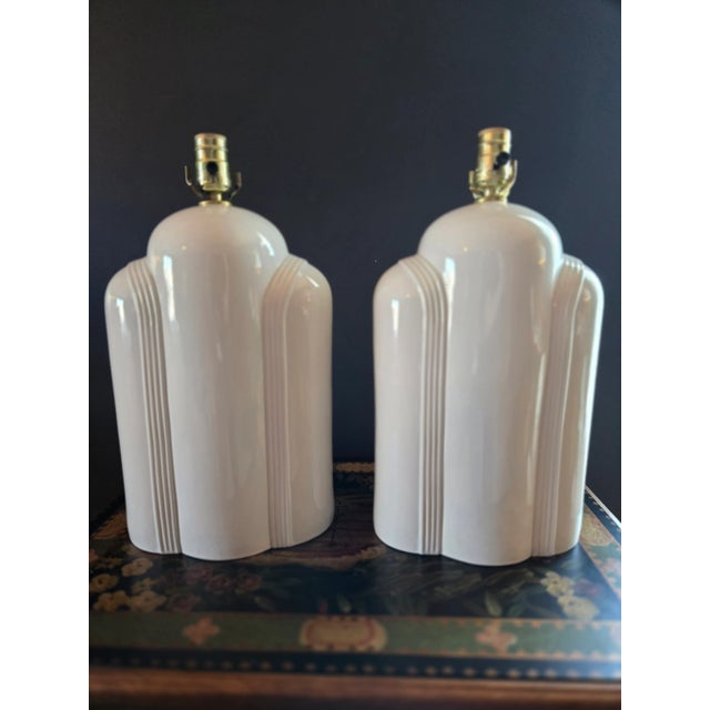 Pair of rare vintage Art Deco table lamps in cream colored ceramic. Measures 17-3/4" from lamp base to the base of the...