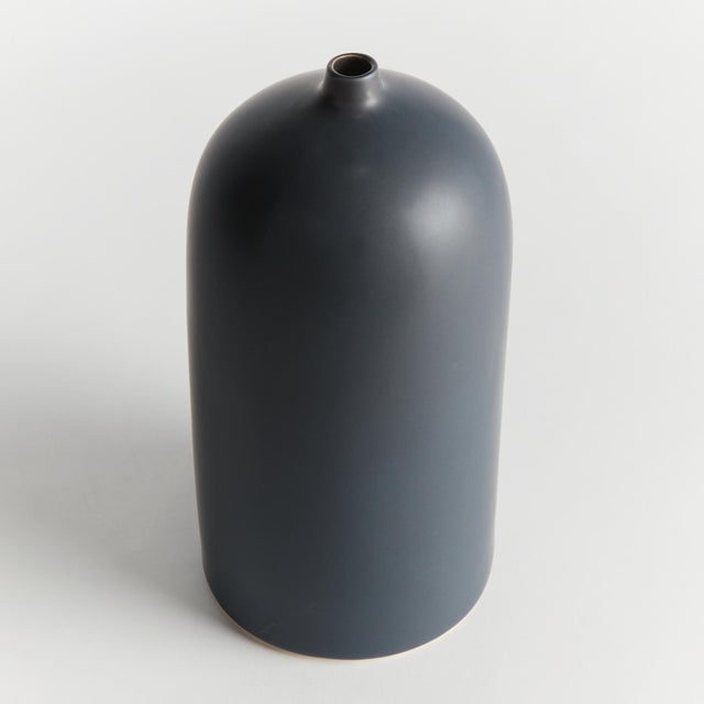 Simple in form with a modern aesthetic, this vase is the definition of less is more. Finished in a smooth dark navy, matte...