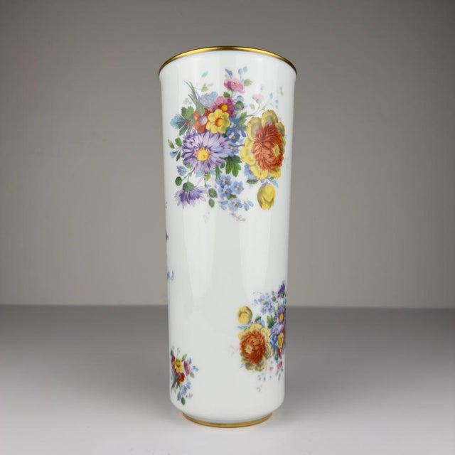 Vintage porcelain vase with flower decorations made in Limoges, France in the 1970s. Hand-painted and gold borders....
