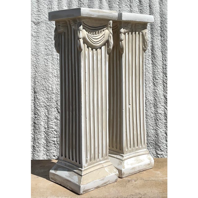Elevate your space with this exquisite pair of vintage cast plaster-over-wood column pedestals, rich in neoclassical...