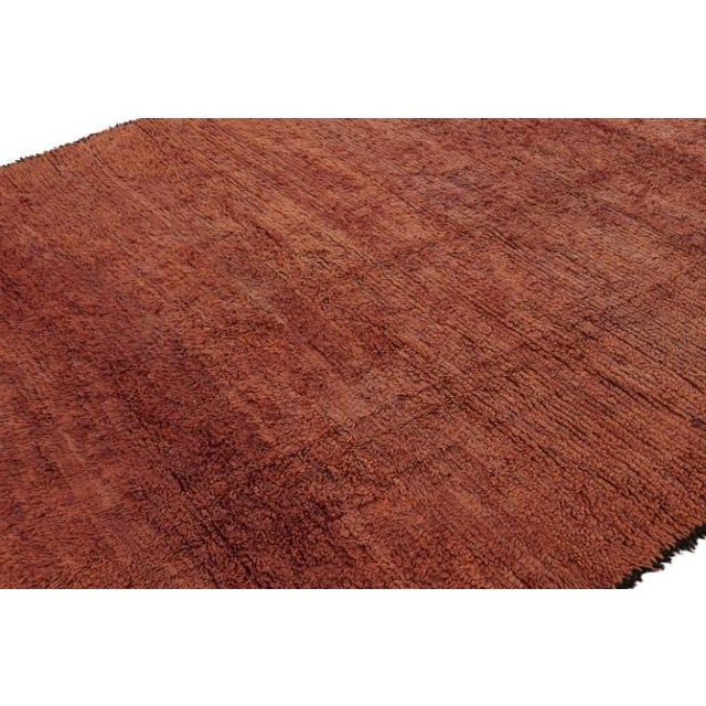 Hand-knotted in wool and originating from Morocco circa 1950-1960, this 7x9 vintage rug is among the most exciting new...