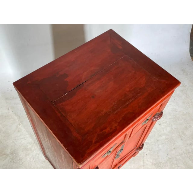 Hand-carved Chinese solid rosewood cabinet in a beautiful soft reddish brown finish with bronze pulls and escutcheons, a...