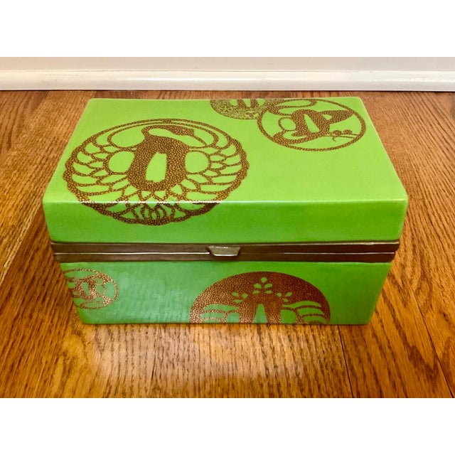 A lovely vintage bright green lidded porcelain dresser box with gold decorations and antique brass by French designer...