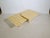 Two-piece nesting table set made of travertine with square tabletops and slightly beveled corners. The tables, of varying...