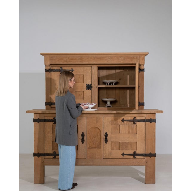 Here is a side cabinet, its natural honey oak, 2 doors, black iron strap hinges the first thing to catch the eye. It was...