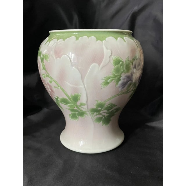A masterful example of late 19th to early 20th-century Japanese porcelain, this elegant vase features a stunning botanical...