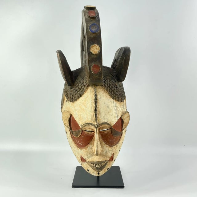 A wonderful Igbo Maiden Spirit Mask from Nigeria, adorned with white pigment. Reflecting typical facial features found on...