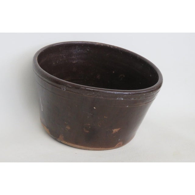his Salt Crock is made out of ceramic. This lovely handmade pottery bowl features a rounded shape with a lovely folk style...