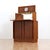 This fantastic mid century bar cabinet was made in England during the 1950s by Sureline. The top cabinet doors open...