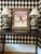 Large framed print by American artist Amado Maurilio Peña Jr., featuring a solitary Indigenous figure set against a...
