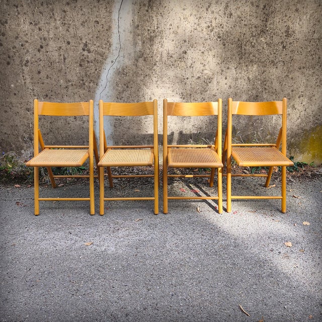 Set of four vintage folding chairs in beech wood with cane seats. Designed and manufactured by Habitat, in the late 1970s...